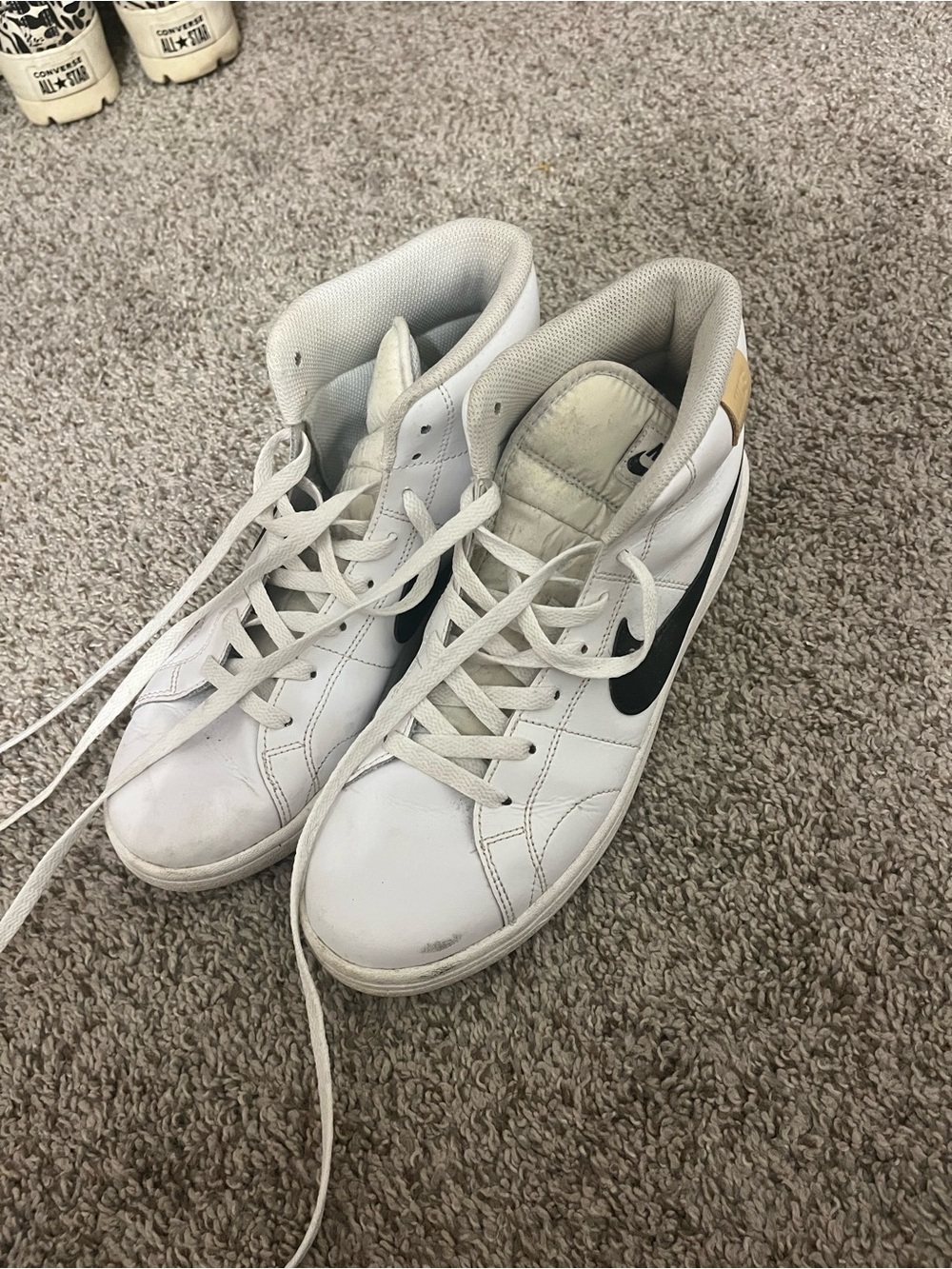 Nike White High-Top Sneakers with Black Swoosh